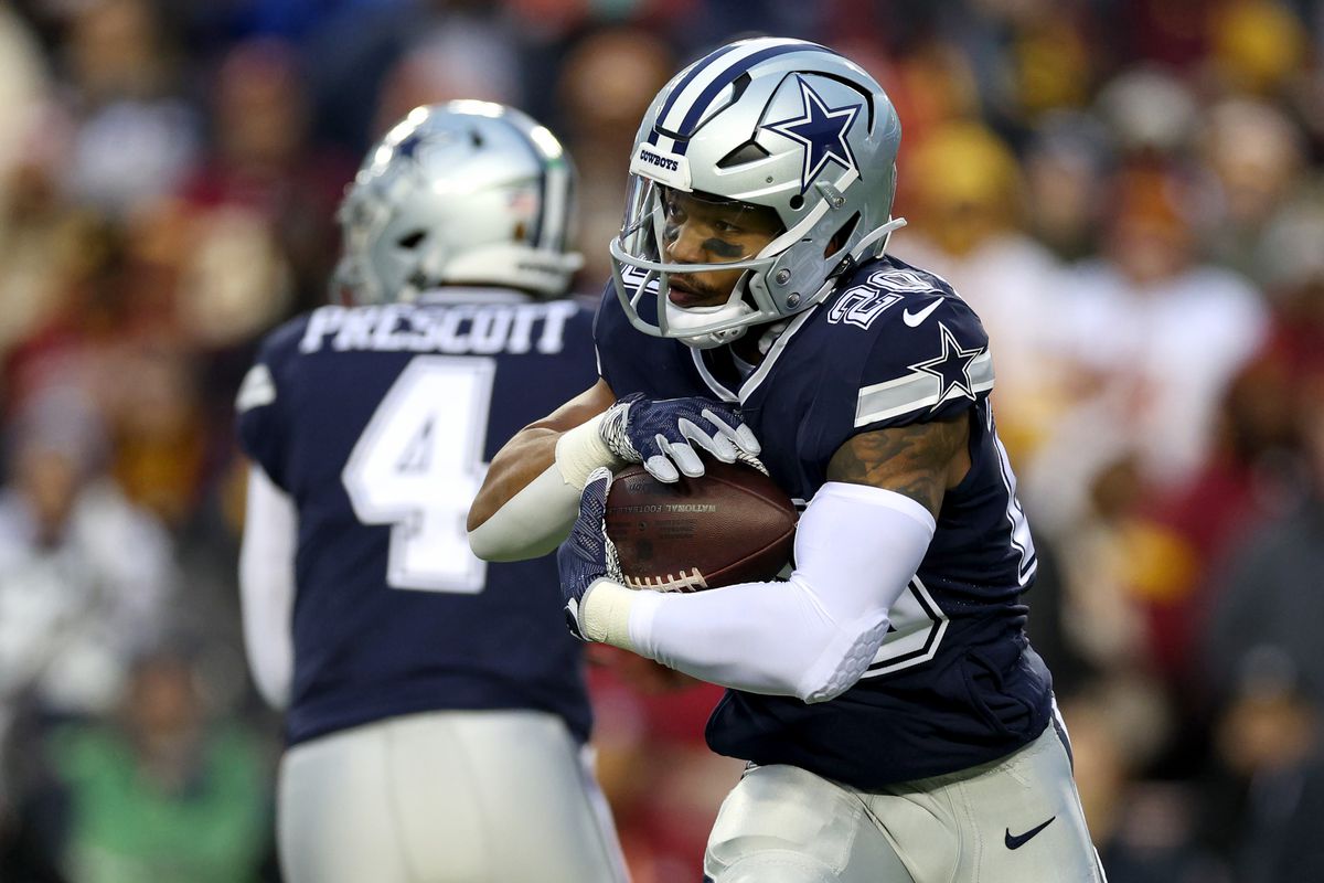 Quarterback Dak Prescott #4 hands the ball off to running back Tony Pollard #20 of the Dallas Cowboys against the Washington Commanders at FedExField on January 08, 2023 in Landover, Maryland.