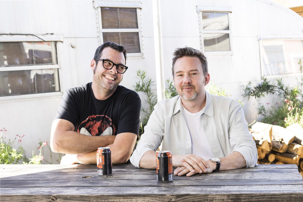 Aaron Franklin (left) and Tyson Cole (right) sitting at a picnic table