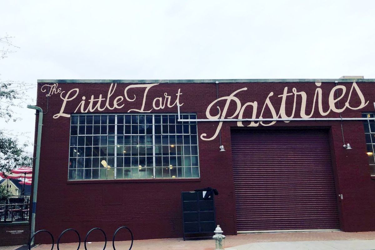 The exterior side of the brick building with of Little Tart Bakeshop in Grant Park with hand-painted Little Tart Pastries 