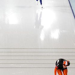 Gold medallist and new Olympic record holder Korea's Lee Seung-Hoon, rear, closes in on Netherlands's Arjen van de Kieft, right, during the men's 10,000 meter speed skating race at the Richmond Olympic Oval at the Vancouver 2010 Olympics in Vancouver, British Columbia, Tuesday.