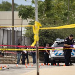Chicago Police investigate at the 25th District station, 5555 W. Grand Ave., on the Northwest Side, after multiple officers were shot outside the station, Thursday morning, July 30, 2020. The suspect was also shot multiple times in the incident.