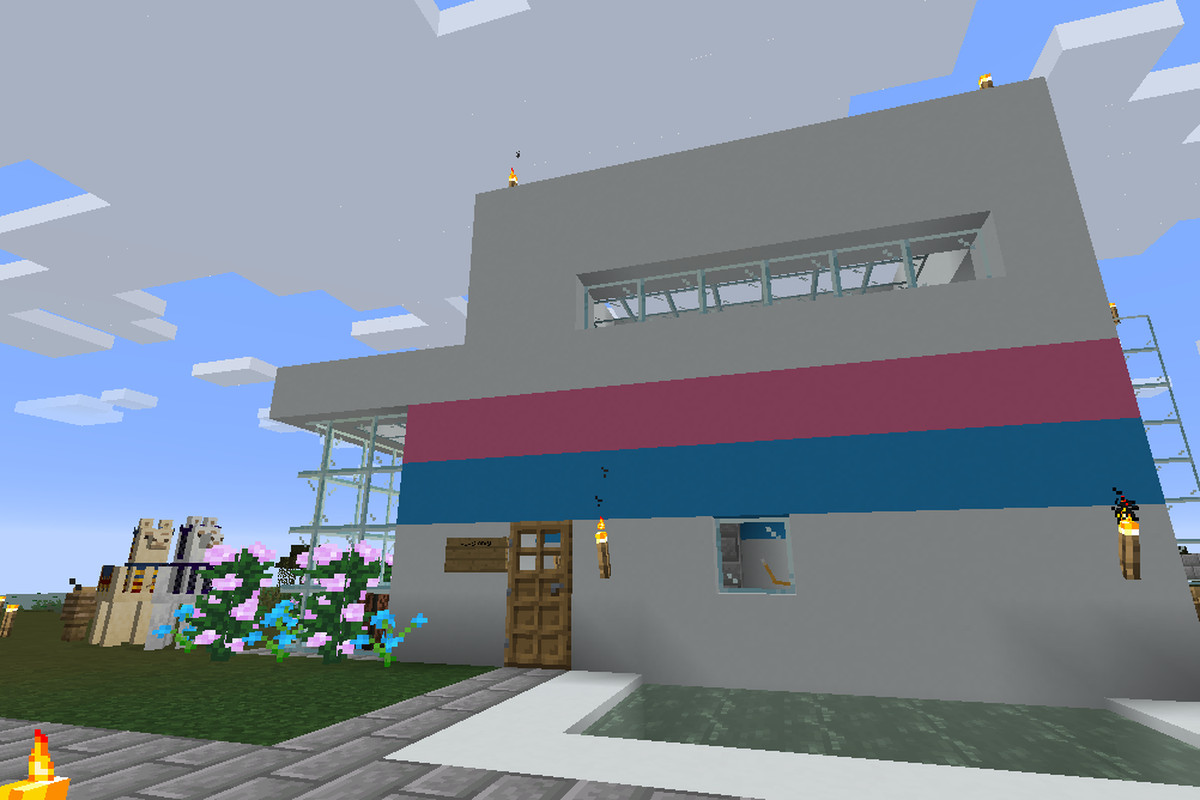 A white lofted Minecraft house with a pink and blue stripe down the middle