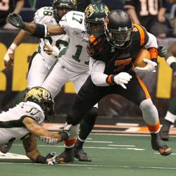 Utah Blaze's Anthony Jackson runs with the ball as San Jose's Huey Whittaker tries to tackle him from behind during a football game between the Utah Blaze and the San Jose SaberCats at EnergySolutions Arena in Salt Lake City on Saturday, June 29, 2013.