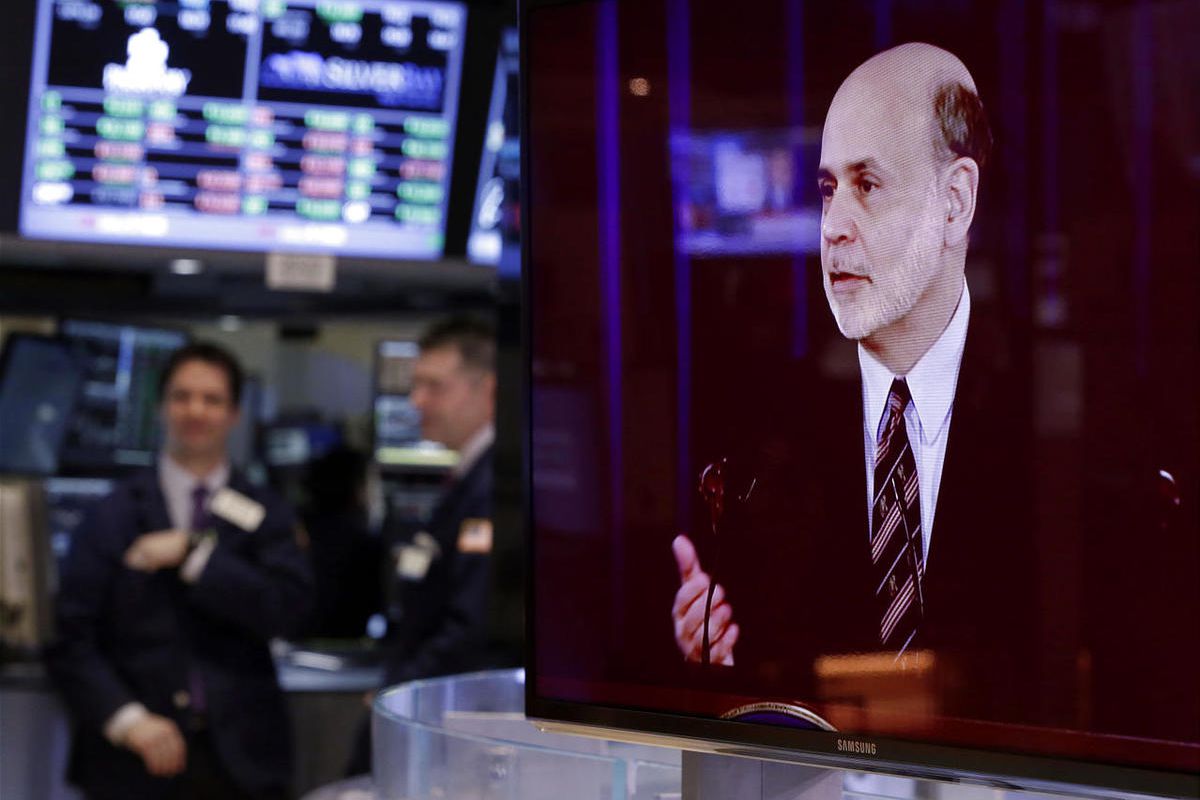 A television screen on the floor of the New York Stock Exchange shows the news conference of Federal Reserve Chairman Ben Bernanke, Wednesday, March 20, 2013.