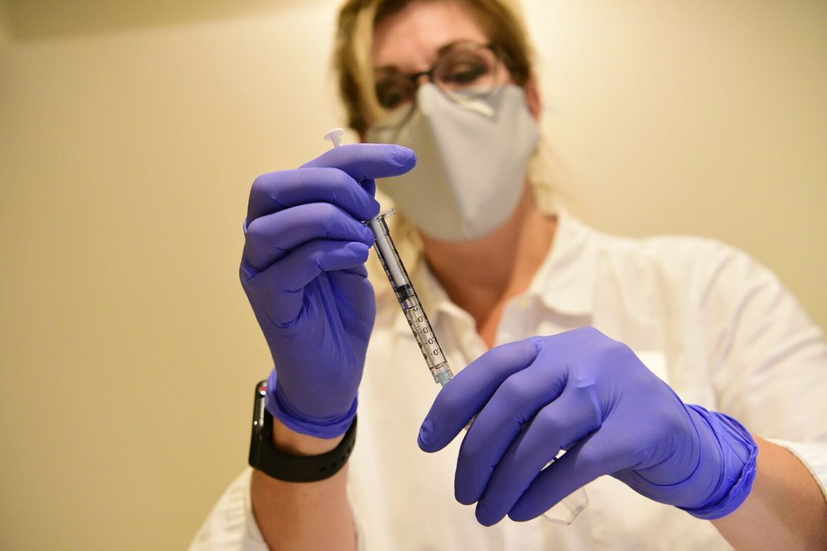 This September 2020, file photo provided by Johnson &amp; Johnson shows a pharmacist preparing to give an experimental COVID-19 vaccine. 