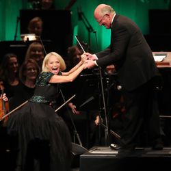 Actress Kristin Chenoweth jokes with conductor Mack Wilberg while singing with The Tabernacle Choir at Temple Square during their annual Christmas concert in Salt Lake City on Thursday, Dec. 13, 2018.
