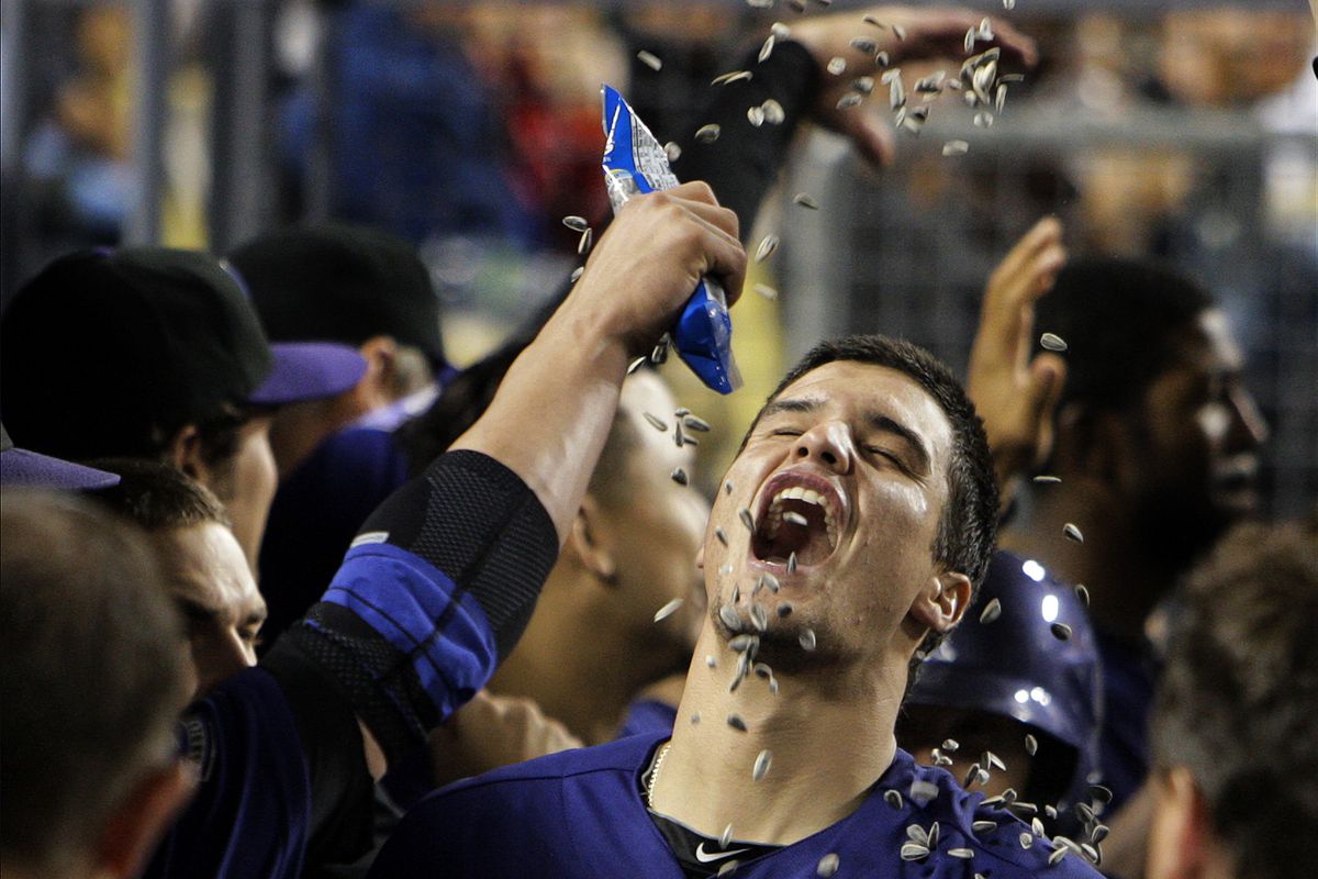 Colorado Rockies third baseman Nolan Arenado (28) is doused with sunflower seeds in the dugout afte