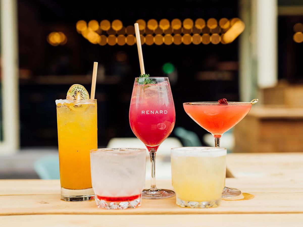 Five cocktails, including a pink one in the middle.