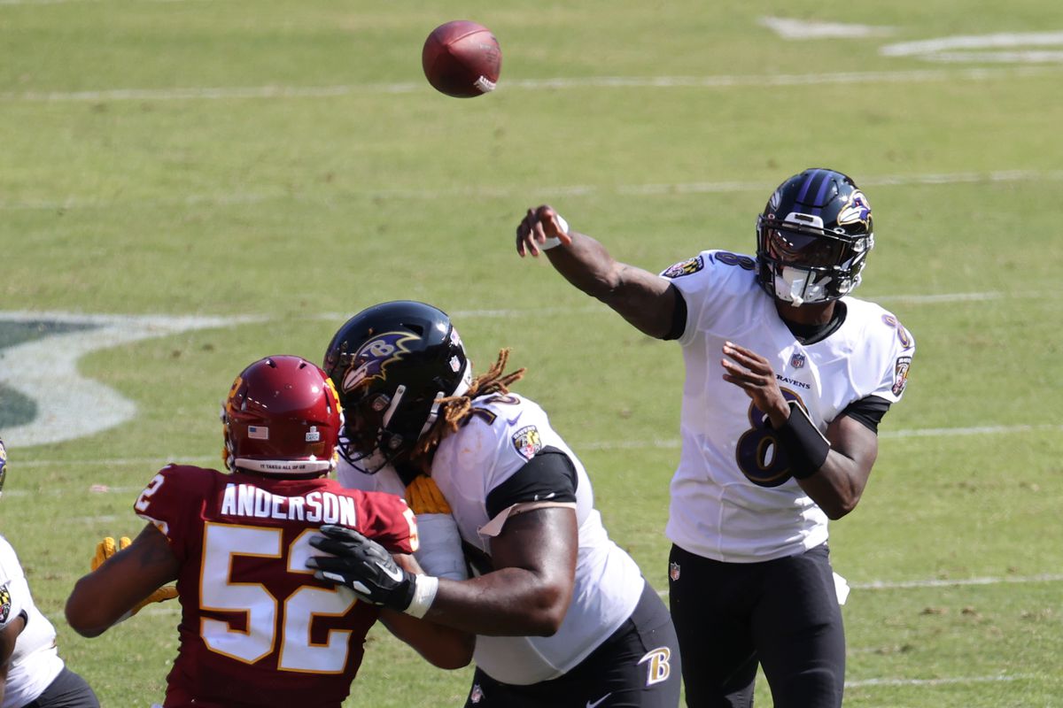 Baltimore Ravens quarterback Lamar Jackson throws a touchdown pass as Washington Football Team defensive end Ryan Anderson defends in the third quarter at FedExField.
