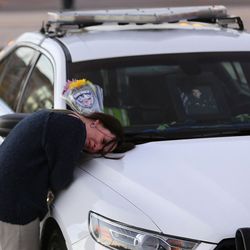 Mandy Richards cries over the patrol car of her nephew, West Valley police officer Cody Brotherson, outside the police station in West Valley City on Monday, Nov. 7, 2016. Brotherson was killed in the line of duty Sunday.