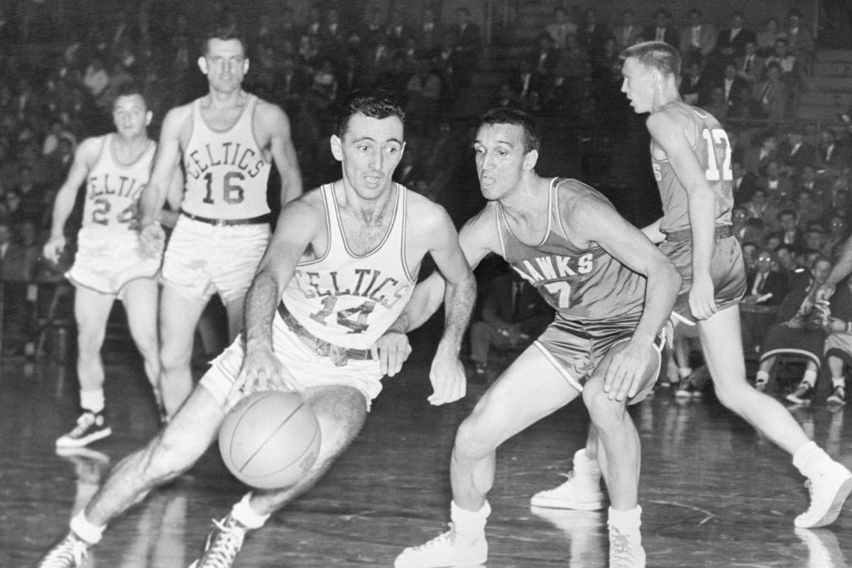 Bob Cousy Dribbling Past an Opponent