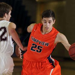 Timpview's Gavin Baxter (25) drives around the defense of Morgan's Bridger Streadbeck (22) during the Riverton Holiday Tournament Championship game on Tuesday, December 31, 2013. 