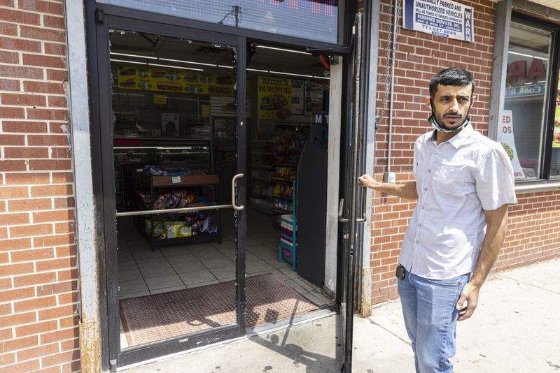 Big Salem’s Food Mart Owner, Maged Salem, holds open the door as he recounts stories of William Crawl, an innocent bystander who was shot outside of Big Salem’s Food Mart at 1724 E. 71st St. in Southshore, Thursday, May 20, 2021. | Anthony Vazquez/Sun-Times