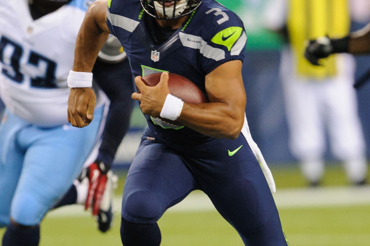 Aug 11, 2012; Seattle, WA, USA; Seattle Seahawks quarterback Russell Wilson (3) runs with the ball during the game against the Tennessee Titans at CenturyLink Field. Seattle defeated Tennessee 27-17. Mandatory Credit: Steven Bisig-US PRESSWIRE