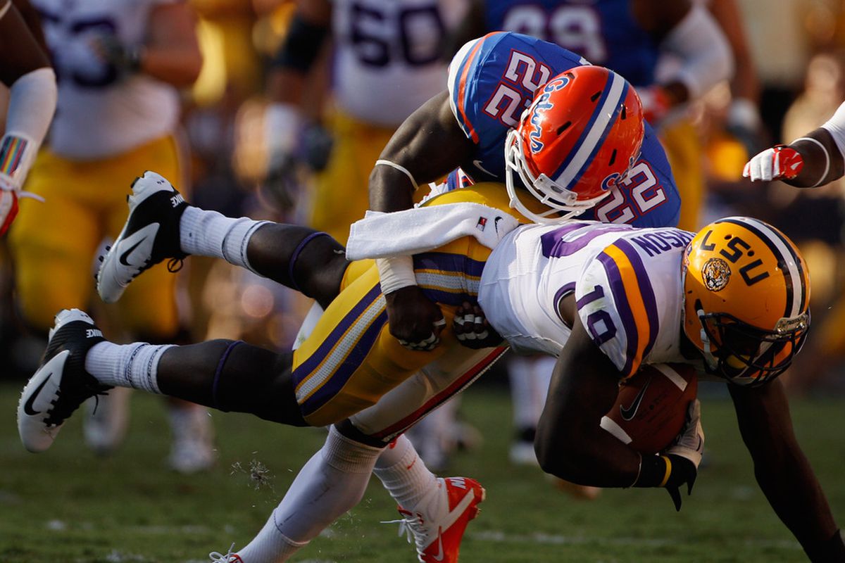 BATON ROUGE, LA - OCTOBER 08:  Deangelo Peterson #19 of the Louisiana State University Tigers is tackled by Matt Elam #22 of the Florida Gators at Tiger Stadium on October 8, 2011 in Baton Rouge, Louisiana.  (Photo by Chris Graythen/Getty Images)