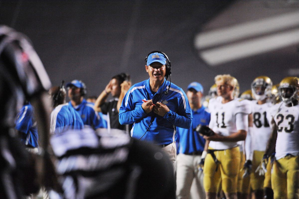 Coach Mora is reaction to quality of referees in college football while it appears Jerry Neuheisel has actual tasks to keep him away from video bombing. Mandatory Credit: Brendan Maloney-US PRESSWIRE