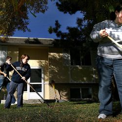 Aubrey Cooper, right, Connie Soderborg and Vincent Beaver of the Taylorsville 1st Ward rake the yard of a home in Taylorsville on Saturday, October 22, 2011. Over 1,000 college aged kids of the Salt Lake Community College LDS Institute participated in the day of service. 