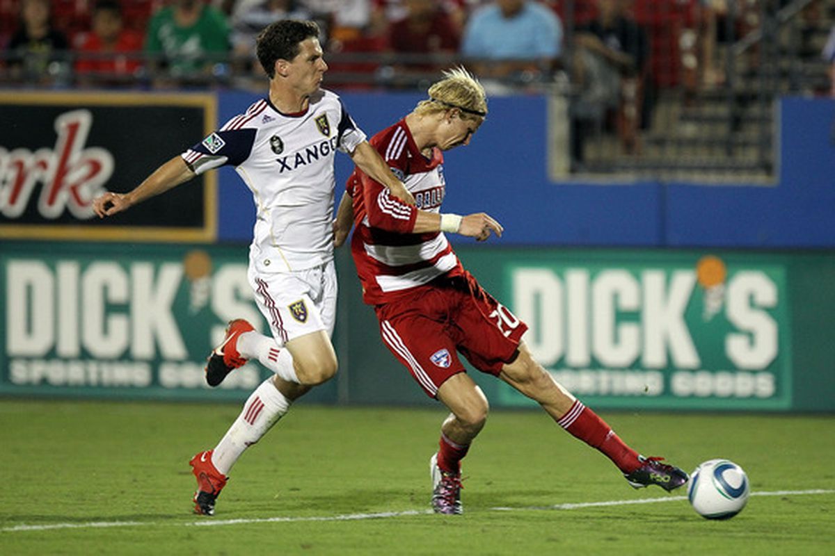 FRISCO TX - JULY 17:  Midfielder Brek Shea #20 of FC Dallas dribbles the ball past Will Johnson #8 of Real Salt Lake at Pizza Hut Park on July 17 2010 in Frisco Texas.  (Photo by Ronald Martinez/Getty Images)