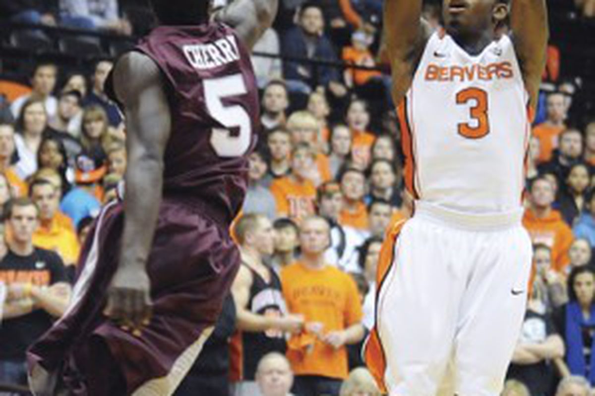 Ahmad Starks, shoots a 3 pointer over Montana's Will Cherry in Oregon St.'s 25 point win Sunday night. <em>(Photo by Jesse Skoubo, originally in the Corvallis Gazette-Times)</em>