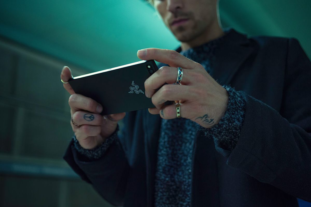 a man holding a Razer smartphone in his hands