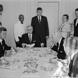 U.S. President John F. Kennedy is second from left as he visits Utah in 1963. At center of the photo is President David O. McKay of The Church of Jesus Christ of Latter-day Saints. Next at the table is Hugh B. Brown.