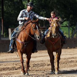 Riley Anderson and his daughter Andee ride horses in Orderville, Kane County, Thursday, Aug. 20, 2015.