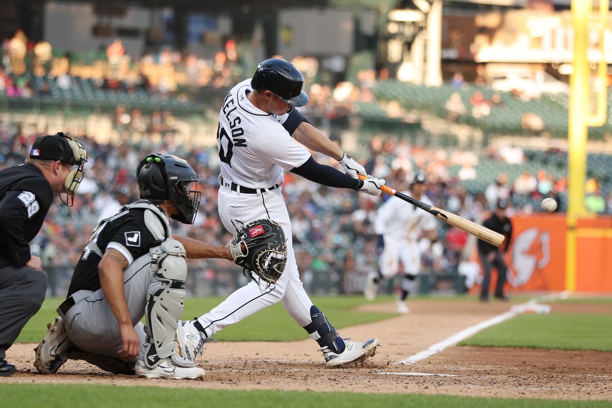 Spencer Torkelson of the Detroit Tigers hits a RBI single in the fourth inning in front of Seby Zavala of the Chicago White Sox at Comerica Park on May 25, 2023 in Detroit, Michigan.