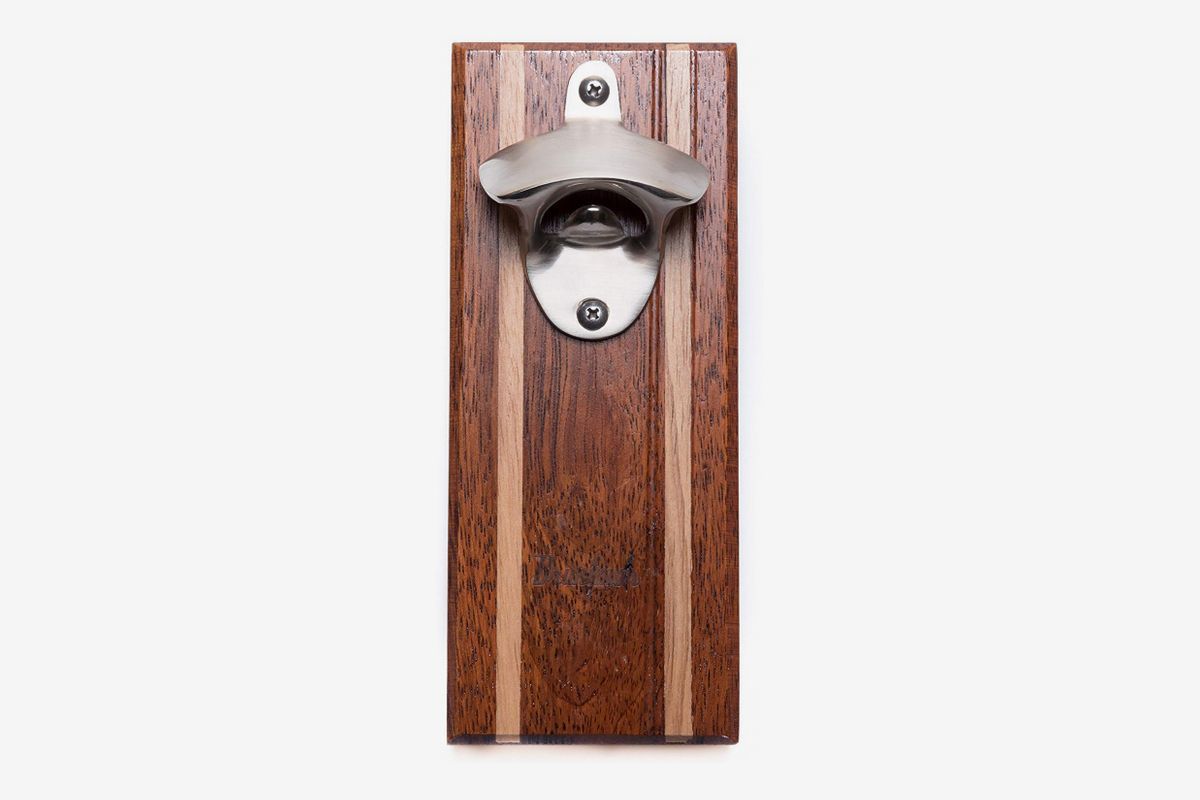 A wooden beer opener with a magnetic cap catcher