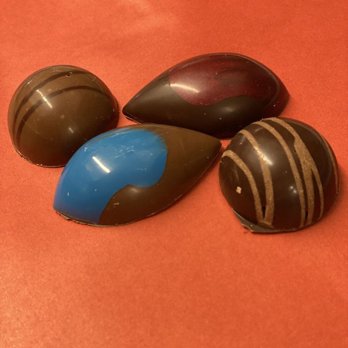 Truffles with colorful stripes on an orange background.