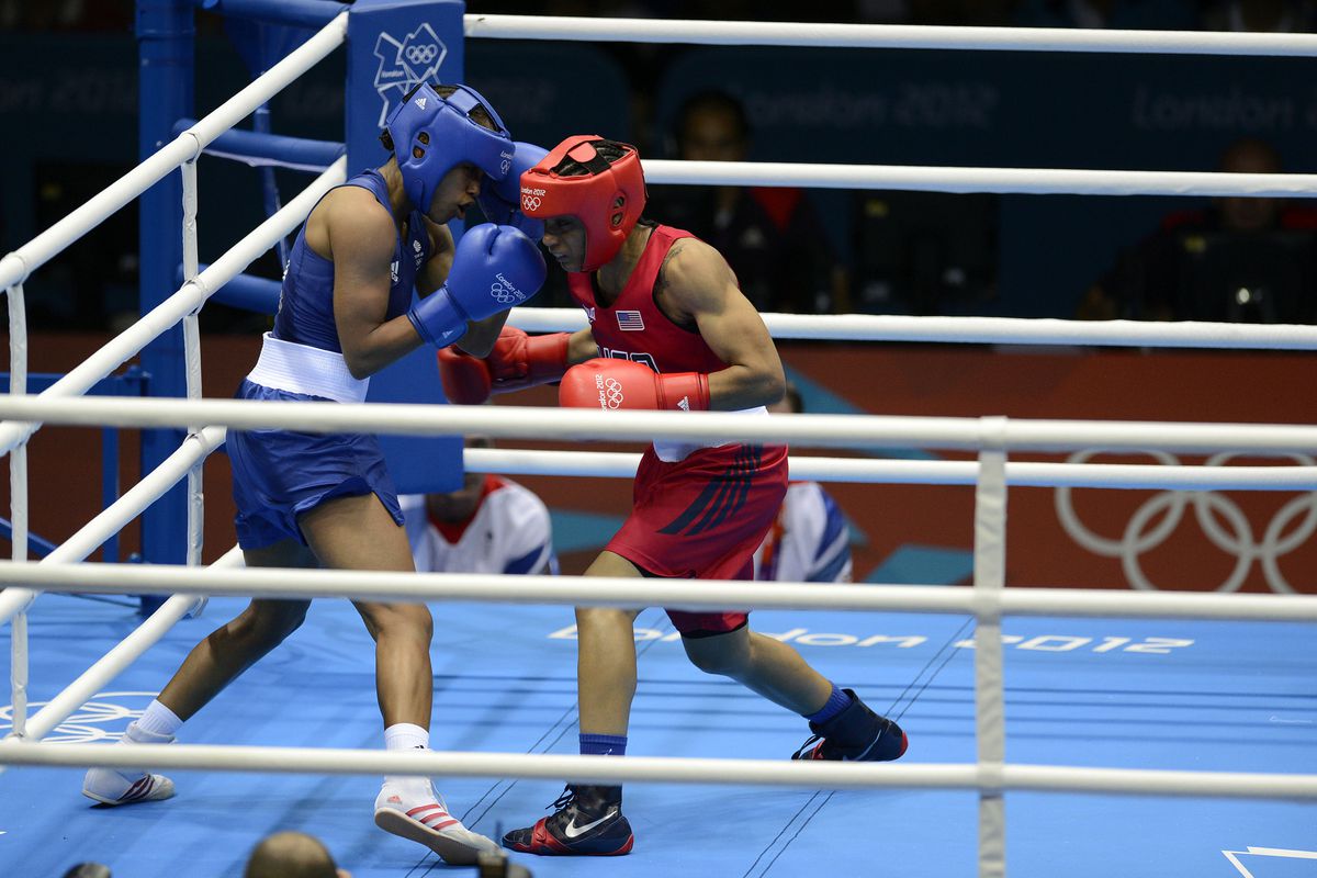 Natasha Jonas of Great Britain (blue) defeated Queen Underwood of the United States (red) on the first day of women's boxing in Olympic history. (Photo by John David Mercer-USA TODAY Sports)