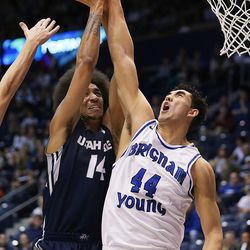 Utah State Aggies forward Jalen Moore (14) is blocked at the hoop by Brigham Young Cougars center Corbin Kaufusi (44) as BYU and Utah State play at the Marriott Center in Provo Wednesday, Dec. 9, 2015.