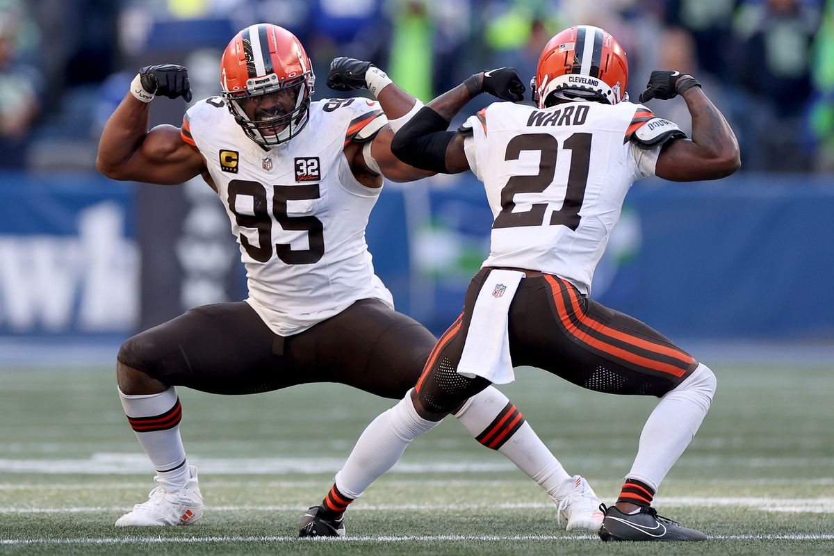 Myles Garrett #95 of the Cleveland Browns celebrates his sack with Denzel Ward #21 during the fourth quarter against the Seattle Seahawks at Lumen Field on October 29, 2023 in Seattle, Washington.