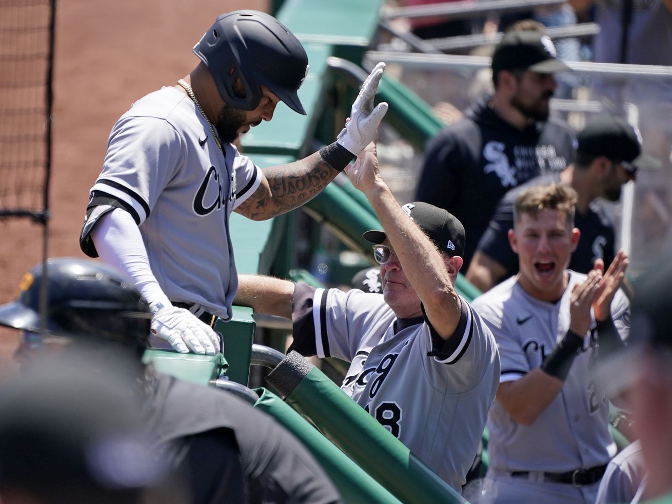 The White Sox’ Leury Garcia, left, is greeted by coach Jerry Narron after hitting a home run off Pirates starting pitcher Chase De Jong during the second inning of Wednesday’s game. 