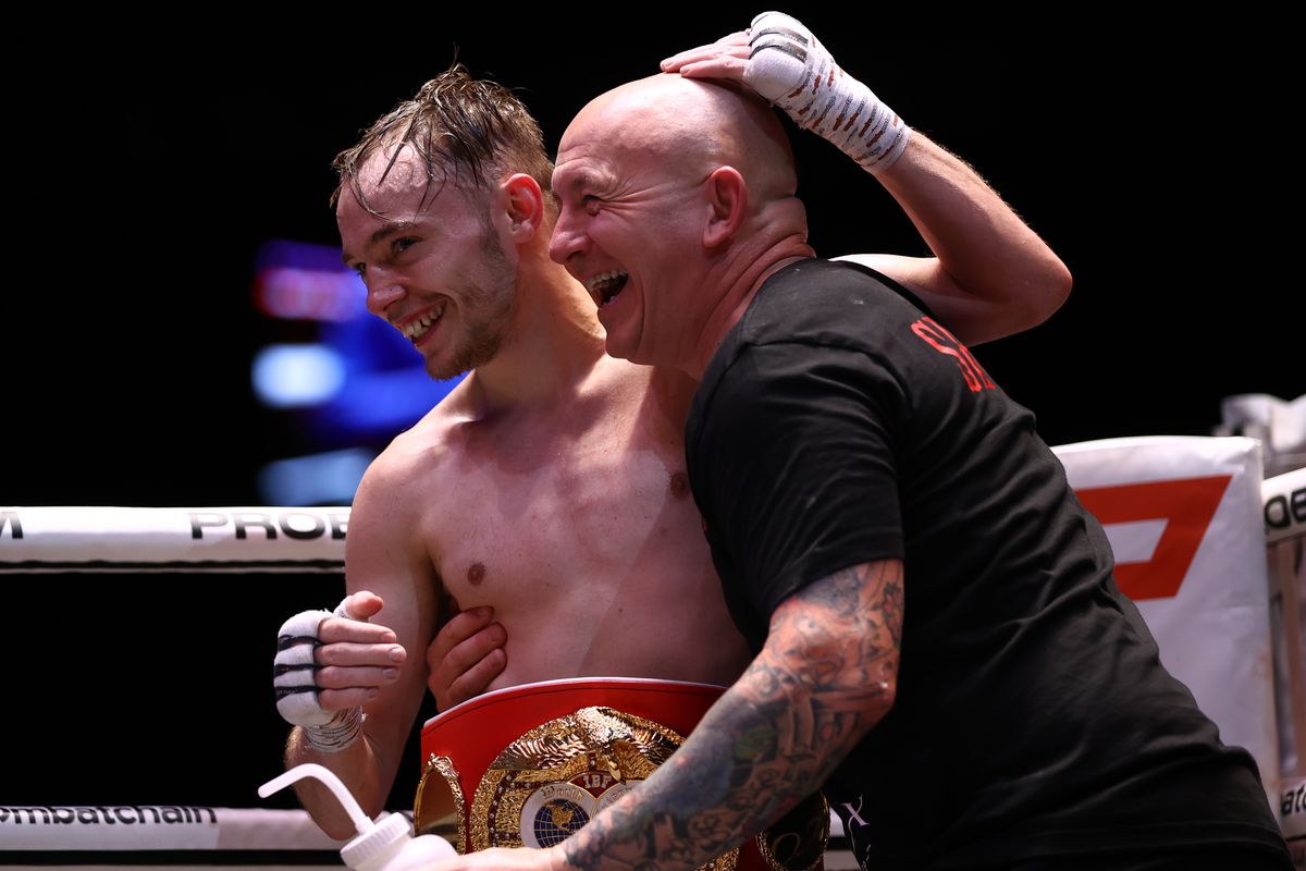 Sunny Edwards and his coach Grant Smith celebrates victory over Jayson Mama during the IBF World flyweight title fight between Sunny Edwards and Jayson Mama at Coca-Cola Arena on December 11, 2021 in Dubai, United Arab Emirates.