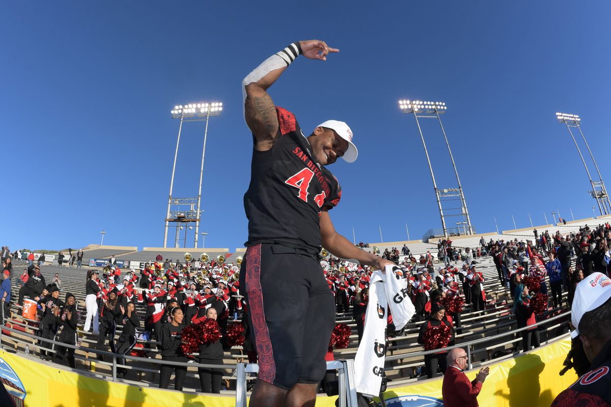 San Diego State linebacker Kyahva Tezino celebrates after the New Mexico Bowl against Central Michigan