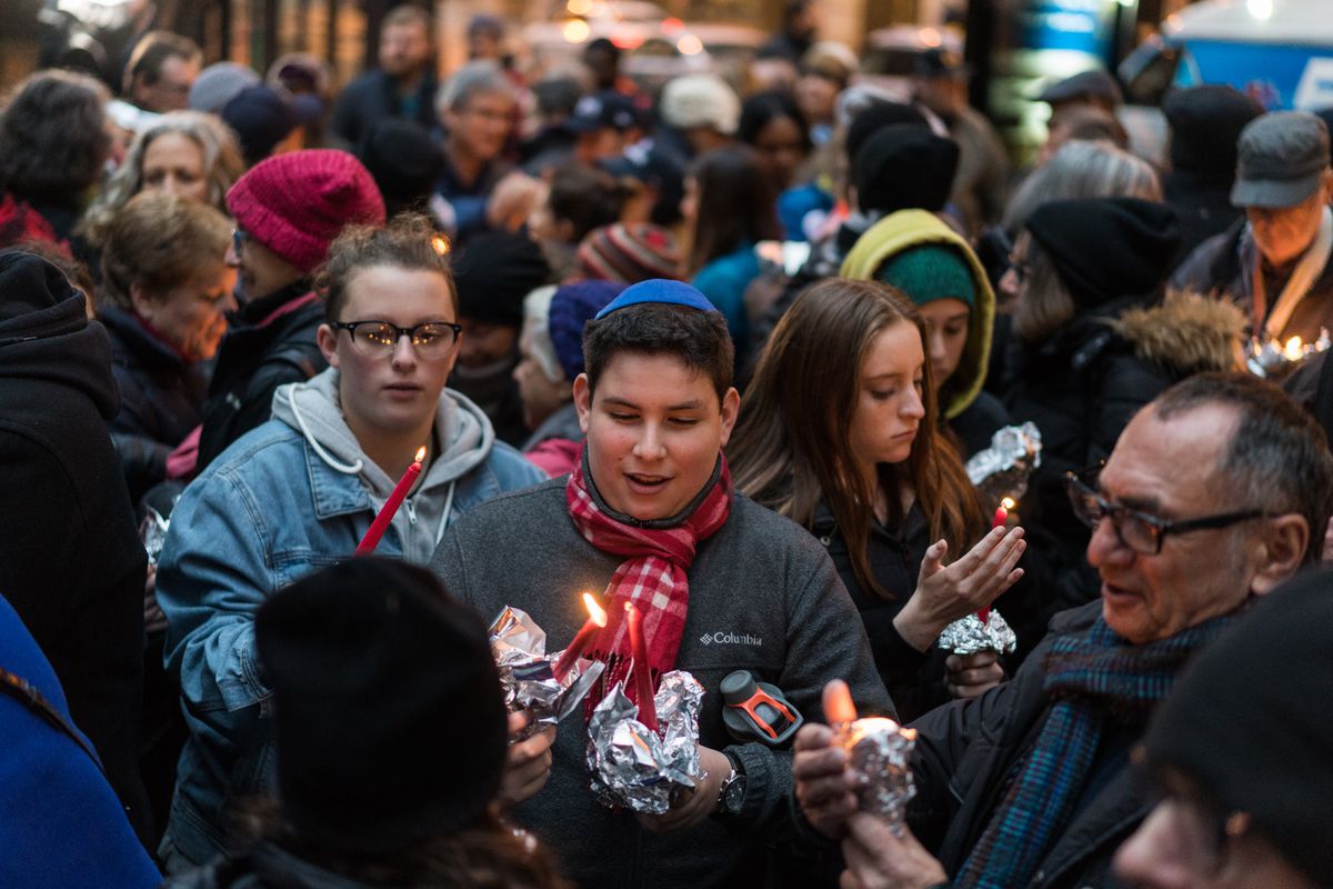 People light candles Sunday, Oct. 28, 2018, before a vigil in Chicago’s Federal Plaza in memory of victims in the Tree of Life synagogue mass shooting in Pittsburgh and other victims of violence. | Max Herman/For the Sun-Times.