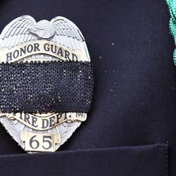 Glade Ridd, of the Utah Firefighters Emerald Society, wears a black band over his badge during graveside services for Jake Shepherd in Mendon on Monday, Nov. 28, 2016. Shepherd was one of three crew members of a medical aircraft that crashed just after takeoff on Nov. 18 while transporting a patient from Elko, Nevada, to University Hospital in Salt Lake City. All four people died in the crash.