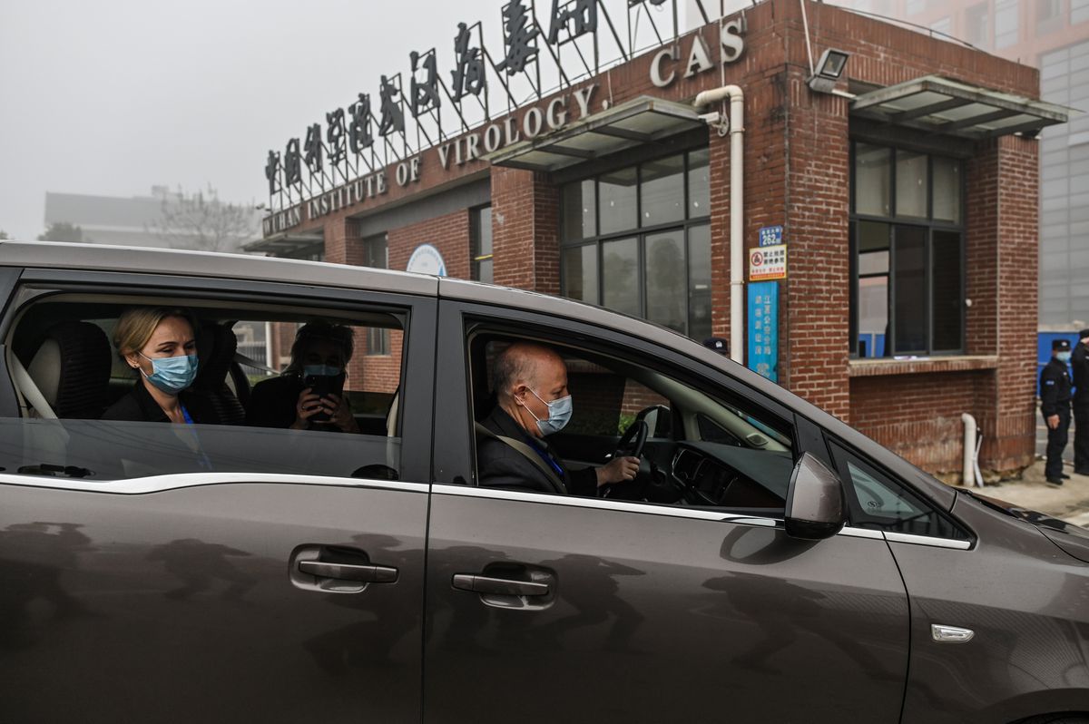 Peter Daszak (R), Thea Fischer (L) and other members of the World Health Organization (WHO) team investigating the origins of the COVID-19 coronavirus, arrive at the Wuhan Institute of Virology in Wuhan in China’s central Hubei province on February 3, 2021. 