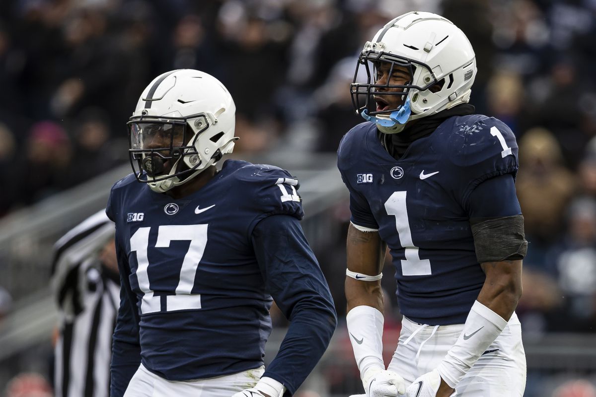 Jaquan Brisker #1 and Arnold Ebiketie #17 of the Penn State Nittany Lions celebrate after a play against the Rutgers Scarlet Knights during the second half at Beaver Stadium on November 20, 2021 in State College, Pennsylvania.