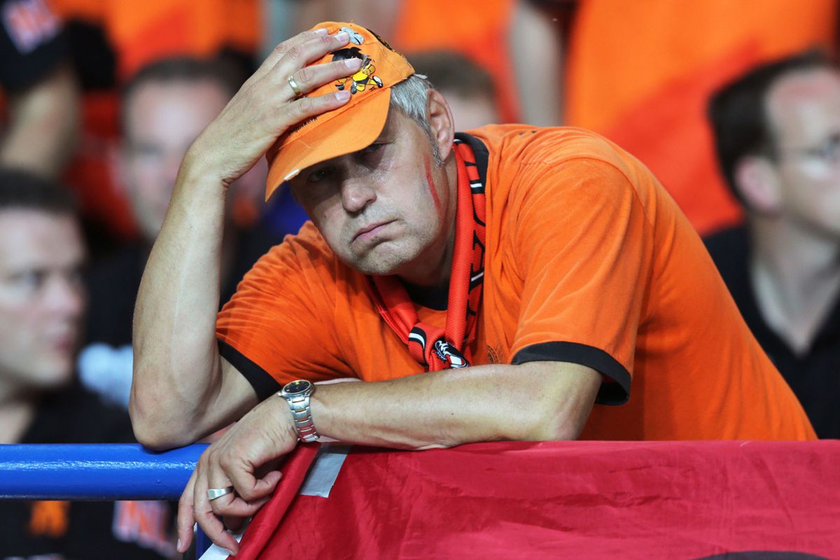 KHARKOV, UKRAINE - JUNE 13:  Netherlands fans look dejected after the UEFA EURO 2012 group B match between Netherlands and Germany at Metalist Stadium on June 13, 2012 in Kharkov, Ukraine.  (Photo by Ian Walton/Getty Images)