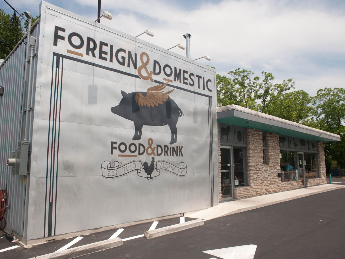 A restaurant front with the words “Foreign &amp; Domestic” on it and a flying pig.
