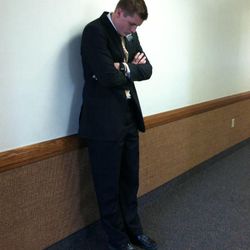 Elder Talon Shumway says a quick prayer in the hall at church. Elder Shumway, a former Lone Peak High basketball player, is serving in the Texas McAllen Mission.