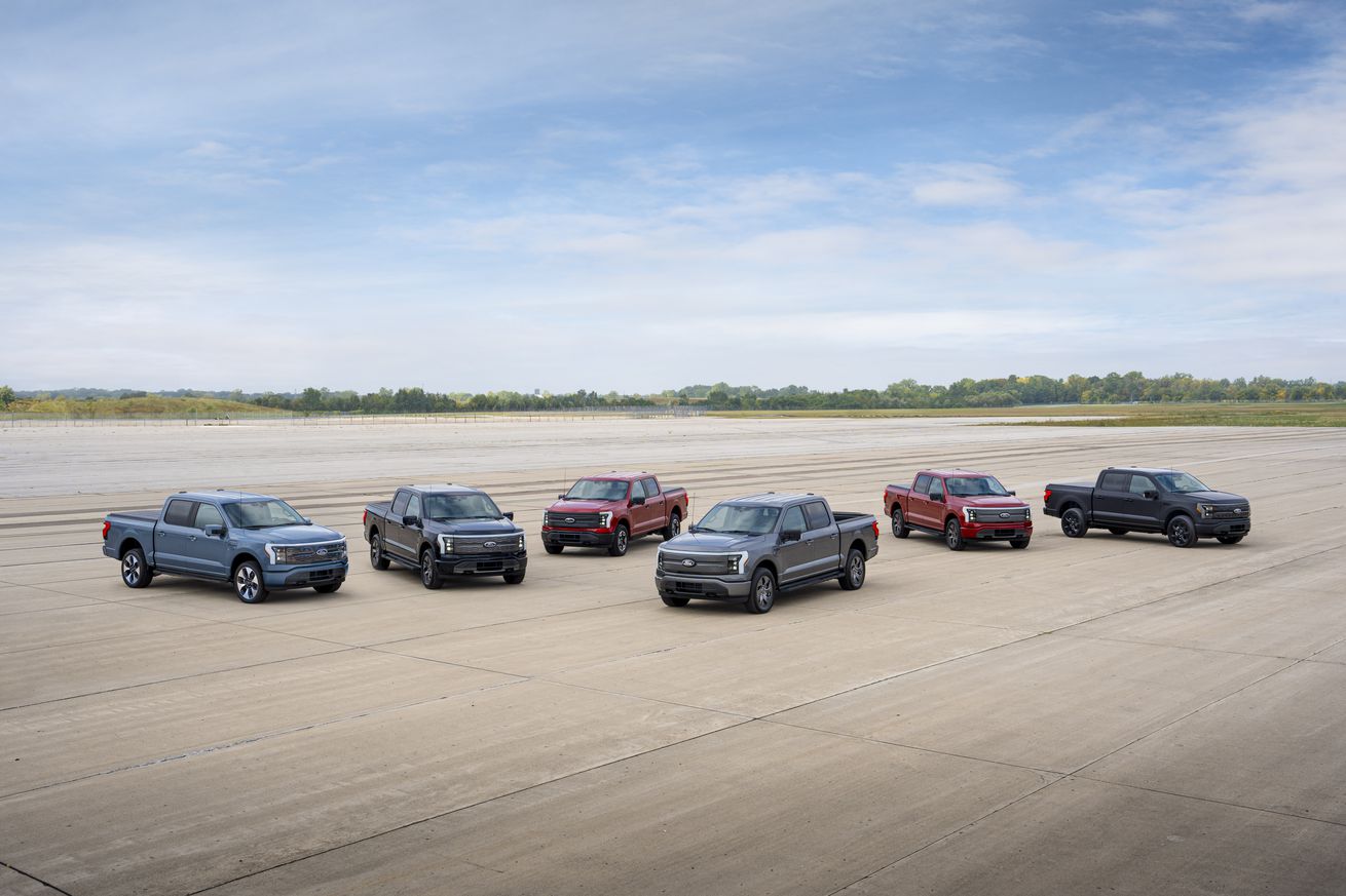 A group photograph of various Ford F-150 Lightning models.