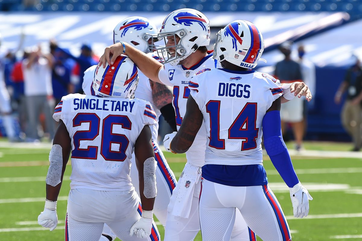 Sep 27, 2020; Orchard Park, New York, USA; Buffalo Bills quarterback Josh Allen (17) celebrates his touchdown run with teammates running back Devin Singletary (26) and wide receiver Stefon Diggs (14) against the Los Angeles Rams during the second quarter at Bills Stadium.