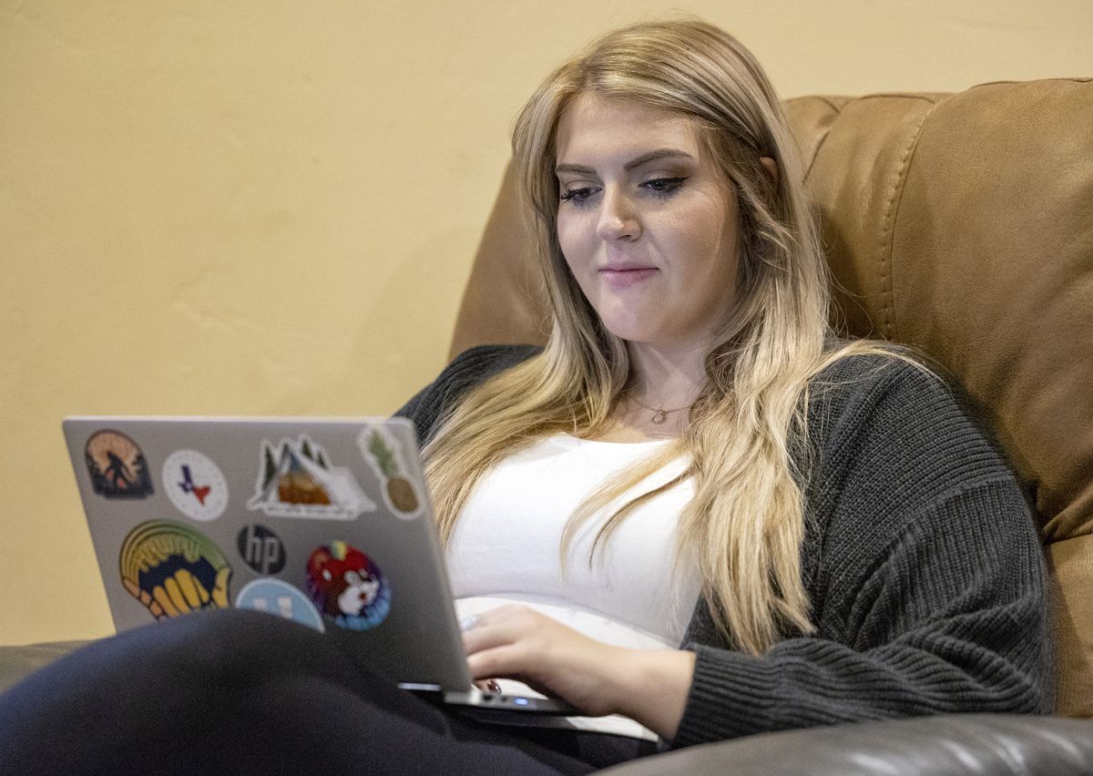 Alexa Minson reads homework on her computer as she poses for photos at her home in Orem on Tuesday, Nov. 2, 2021.
