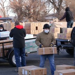 Volunteers of The Church of Jesus Christ of Latter-day Saints distribute USDA food boxes at a Church meetinghouse on the Fort Hall Reservation in southeastern Idaho on Monday, Feb. 1, 2021.