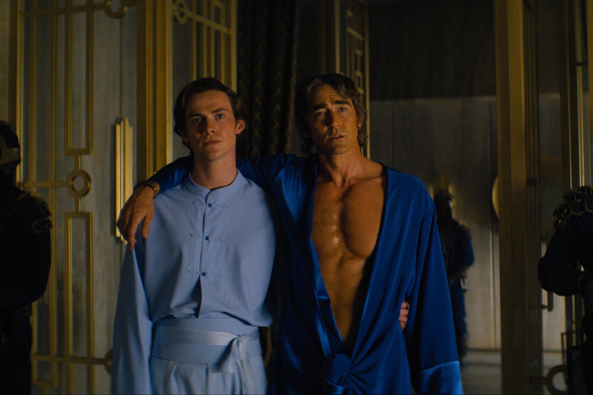 Brother Dawn (Cassian Dilton) standing with his arm around Brother Day (Lee Pace) in a still from Foundation
