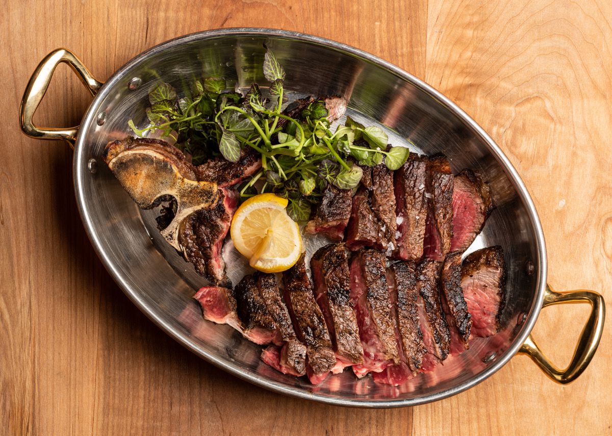 Dry-aged bistecca from Fia Steak in Santa Monica in a metal pan.
