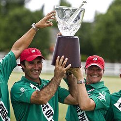 The Dean's Demons  —  Santiago Mendez, Argentina; Luis Saracco, Argentina; Jennifer Luttrell, Salt Lake City; and Ignacio Saracco, Argentina  —  show their trophy to the crowd Saturday after beating the Miller 4-Runners. The first Pharmacy Cup match benefited the University of Utah College of Pharmacy. The event brought polo back to the Salt Lake area for the first time since 1943.