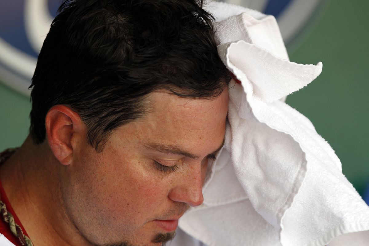 Boston, MA, USA; Boston Red Sox pitcher Josh Beckett (19) wipes his forehead during the fourth inning against the Texas Rangers at Fenway Park.  Mandatory Credit: Greg M. Cooper-US PRESSWIRE